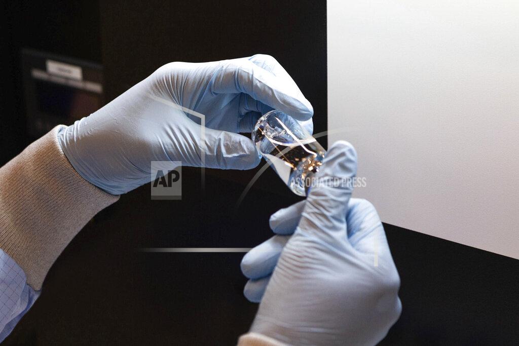 FILE - In this March 2020 photo provided by Gilead Sciences, a vial of the investigational drug remdesivir is visually inspected at a Gilead manufacturing site in the United States. Given through an IV, the medication is designed to interfere with an enzyme that reproduces viral genetic material. (Gilead Sciences via AP)