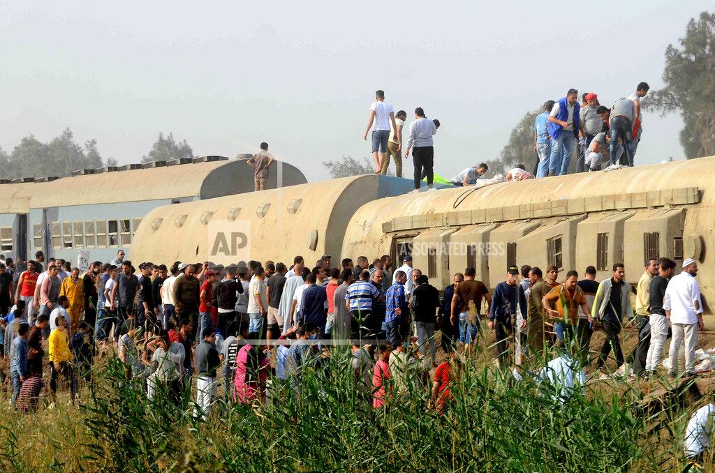 Tarek Wagih People gather at the site where a passenger train derailed injuring at least 100 people, near Banha, Qalyubia province, Egypt, Sunday, April 18, 2021. At least eight train wagons ran off the railway, the provincial governor's office said in a statement. (AP Photo/Tarek Wagih)