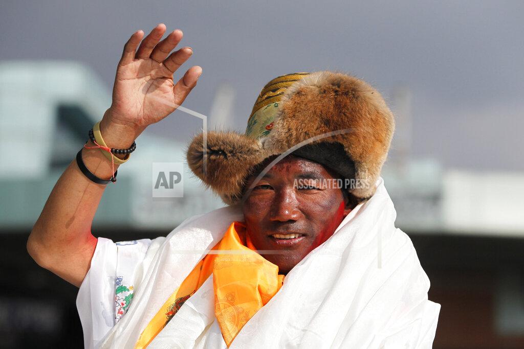 FILE - In this May 20, 2018, file photo, Nepalese veteran Sherpa guide, Kami Rita waves as he arrives in Kathmandu, Nepal. Rita, 51, an ace Sherpa guide scaled Mount Everest Friday for the 25th time breaking his own record for the most successful ascents of the world’s highest peak. (AP Photo/Niranjan Shrestha, File)