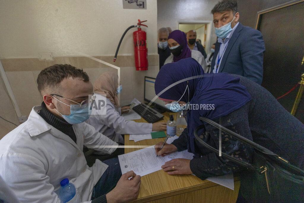 Nasser Nasser Palestinians register to receive their first dose a of the Pfizer COVID-19 vaccine during a campaign to vaccinate front-line workers, those over 75, cancer patients and medical personnel, at the health ministry in the West Bank city of Ramallah, Sunday, March 21, 2021. On Sunday the Palestinian Health Ministry began administering the first coronavirus vaccines received through the global COVAX initiative to eligible people in the West Bank and Gaza Strip. (AP Photo/Nasser Nasser)