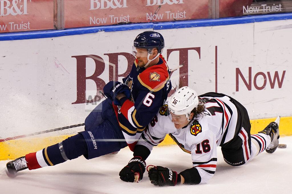 Wilfredo Lee Florida Panthers defenseman Anton Stralman (6) and Chicago Blackhawks defenseman Nikita Zadorov (16) collide as they vie for the puck during the third period of an NHL hockey game, Saturday, March 13, 2021, in Sunrise, Fla. (AP Photo/Wilfredo Lee)