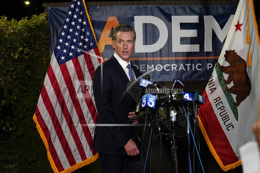 Rich Pedroncelli California Gov. Gavin Newsom walks to the podium to talk with reporters, after beating back the recall attempt that aimed to remove him from office, at the John L. Burton California Democratic Party headquarters in Sacramento, Calif., Tuesday, Sept. 14, 2021. (AP Photo/Rich Pedroncelli)