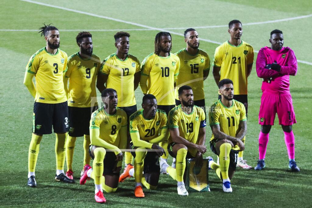 Ronald Zak Jamaica players stand during the national anthem prior the international friendly soccer match between USA and Jamaica at SC Wiener Neustadt stadium in Wiener Neustadt, Austria, Thursday, March 25, 2021. (AP Photo/Ronald Zak)