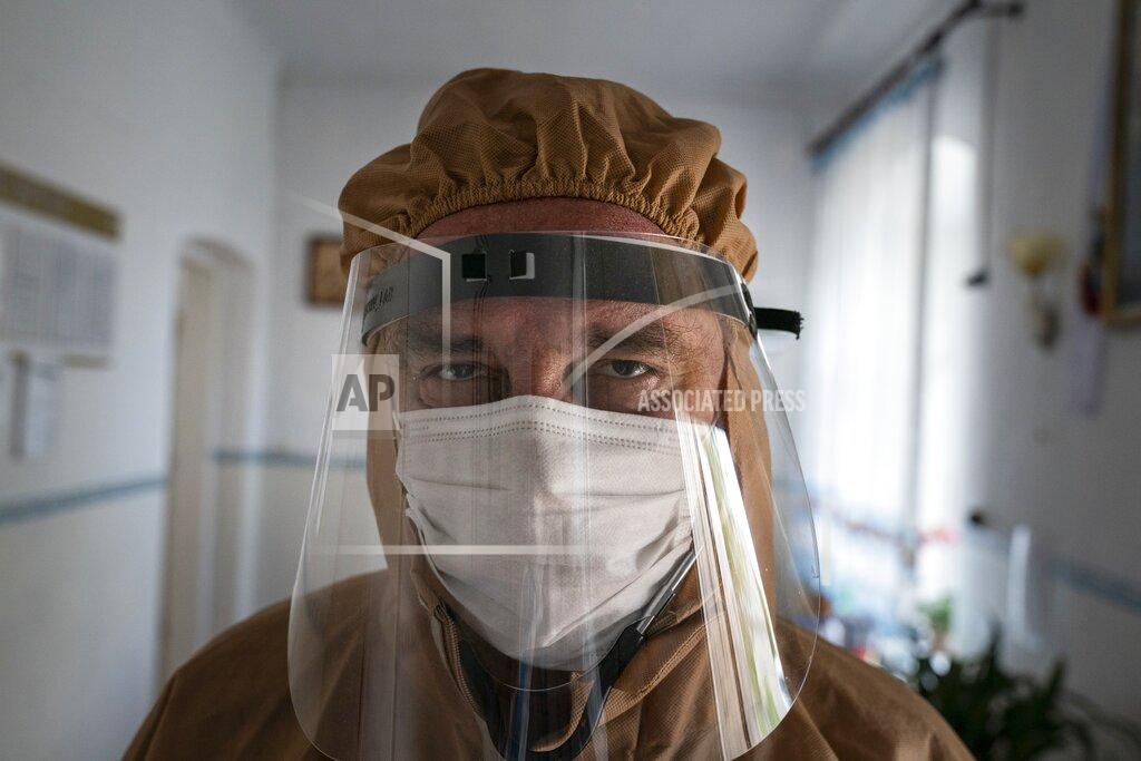 Evgeniy Maloletka FILE - In this May 1, 2020, file photo, Dr. Ivan Venzhynovych speaks to The Associated Press after morning rounds with coronavirus patients at a hospital in Pochaiv, Ukraine. Venzhynovych later died of double pneumonia, which his colleagues believed was caused by the virus even though he tested negative for it. “He certainly had COVID-19,” said Venzhynovych's widow, Iryna, a doctor at the hospital where he worked. (AP Photo/Evgeniy Maloletka, File)