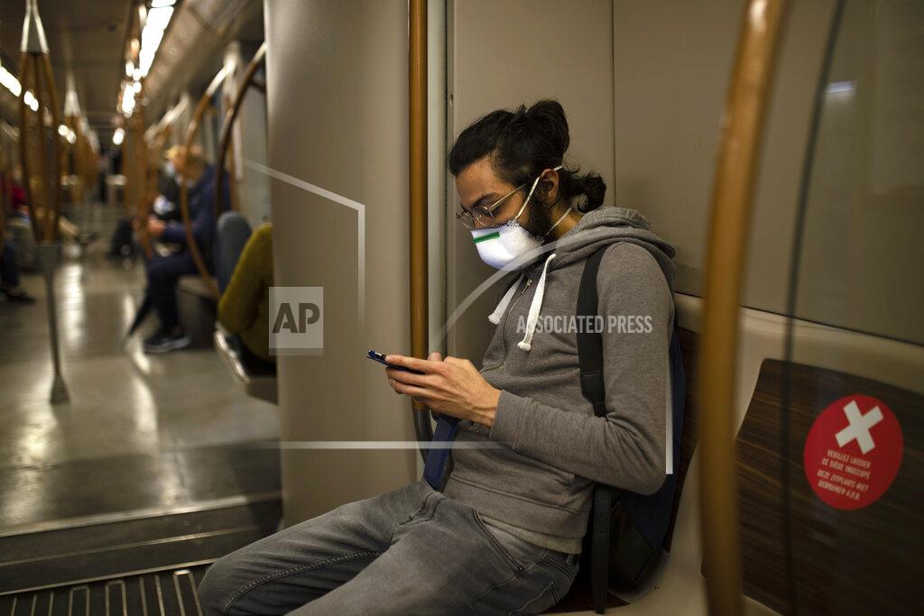 Francisco Seco A man wearing a face mask to protect against coronavirus travels in metro during a gradual lifting of a lockdown to prevent the spread of the coronavirus, COVID-19, in Brussels, Monday, May 4, 2020. Belgium is relaxing some of its lockdown measures Monday. Business-to-business companies can open their offices to employees again and those taking public transport must wear a mask. (AP Photo/Francisco Seco)