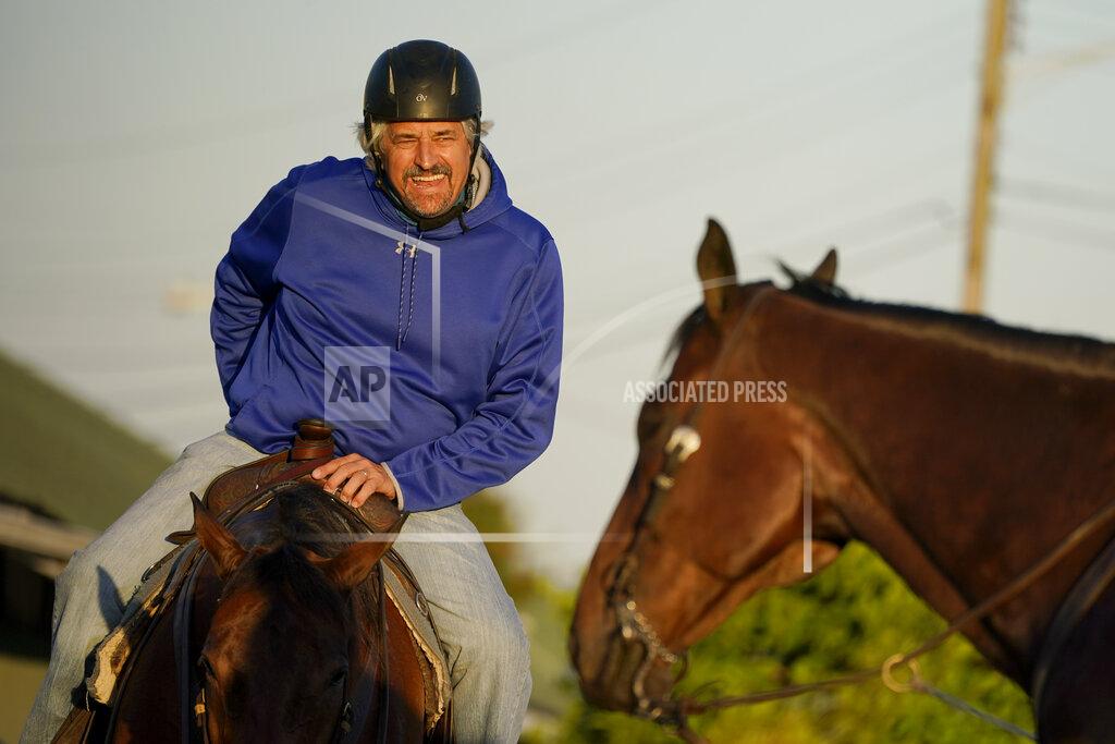 Charlie Riedel Trainer Steve Asmussen waits to take Kentucky Derby hopeful Super Stock on the track at Churchill Downs Tuesday, April 27, 2021, in Louisville, Ky. Asmussen's parents co-own the horse along with a partner. (AP Photo/Charlie Riedel)