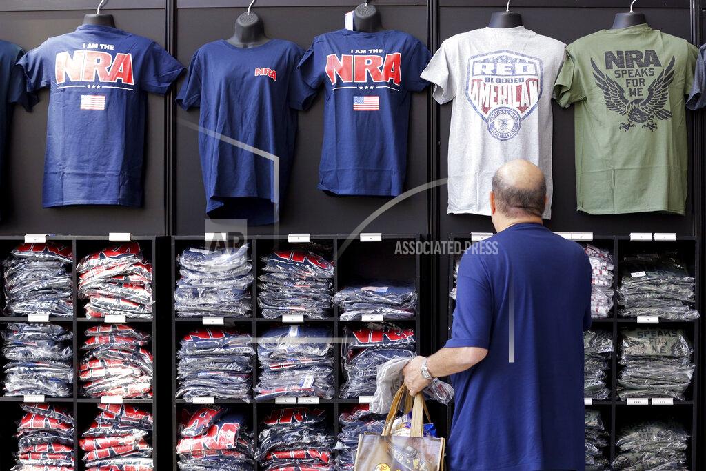 Michael Wyke A convention attendee looks at NRA branded shirts for sale at the NRA Store at the NRA Annual Meeting held at the George R. Brown Convention Center Thursday, May 26, 2022, in Houston. (AP Photo/Michael Wyke)