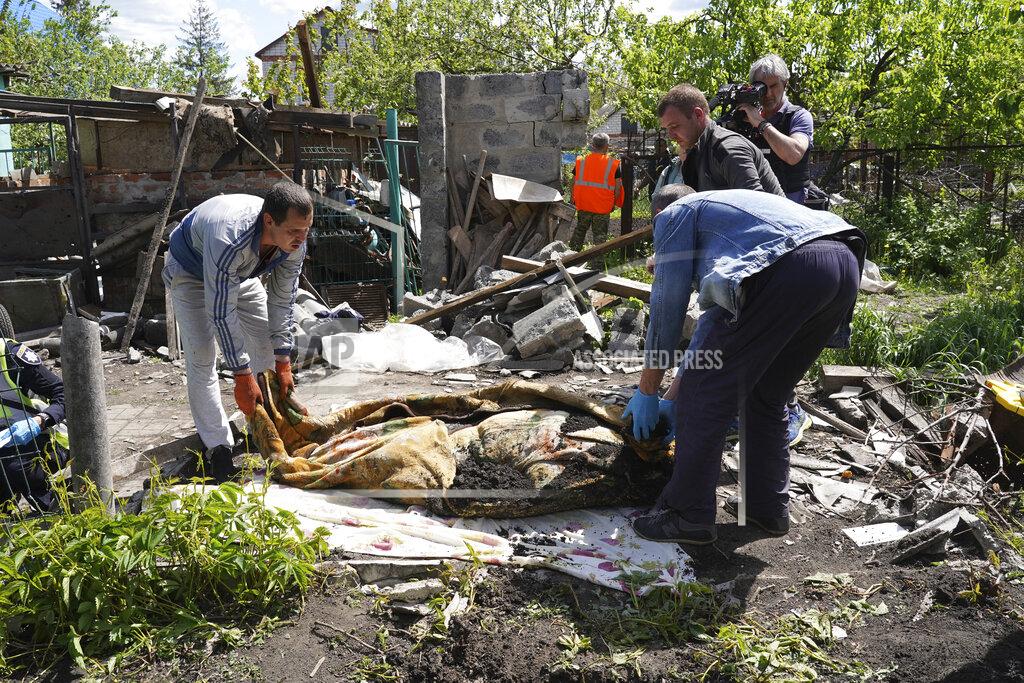Andrii Marienko Police and volunteers exhume the body of a civilian killed by Russian shelling in the village of Malaya Rohan, on the outskirts of Kharkiv, Monday, May 16, 2022. (AP Photo/Andrii Marienko)