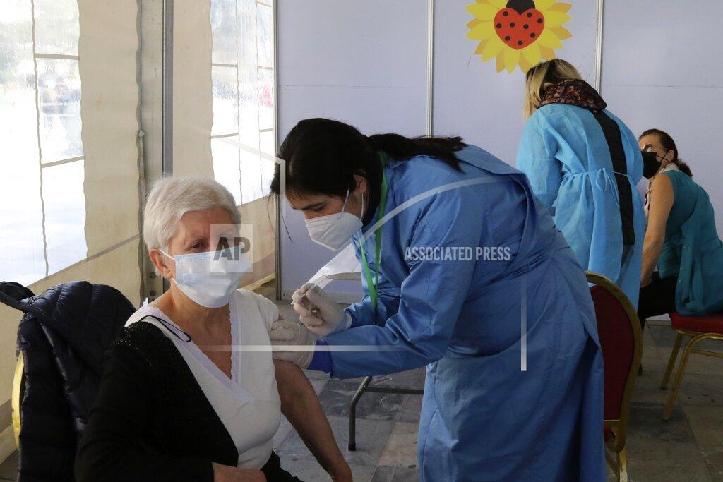 Hektor Pustina An elderly woman receives a dose of Sinovac COVID-19 vaccine in Tirana, Albania, Sunday, March 28, 2021. Albania started a mass vaccination campaign trying to inoculate half a million people opening the way to a more relaxed incoming summer tourism season. (AP Photo/Hektor Pustina)