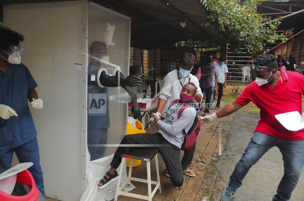 Mahesh Kumar A A man reacts as health workers help collect a nasal swab sample to test for COVID-19 in Hyderabad, India, Thursday, Sept. 17, 2020. As India’s coronavirus confirmed cases jump by a record 97,894 cases in the past 24 hours, Prime Minister Narendra Modi’s government faced a scathing opposition criticism in Parliament for its handling of the pandemic and a contracting economy leaving millions jobless on Thursday. (AP Photo/Mahesh Kumar A.)