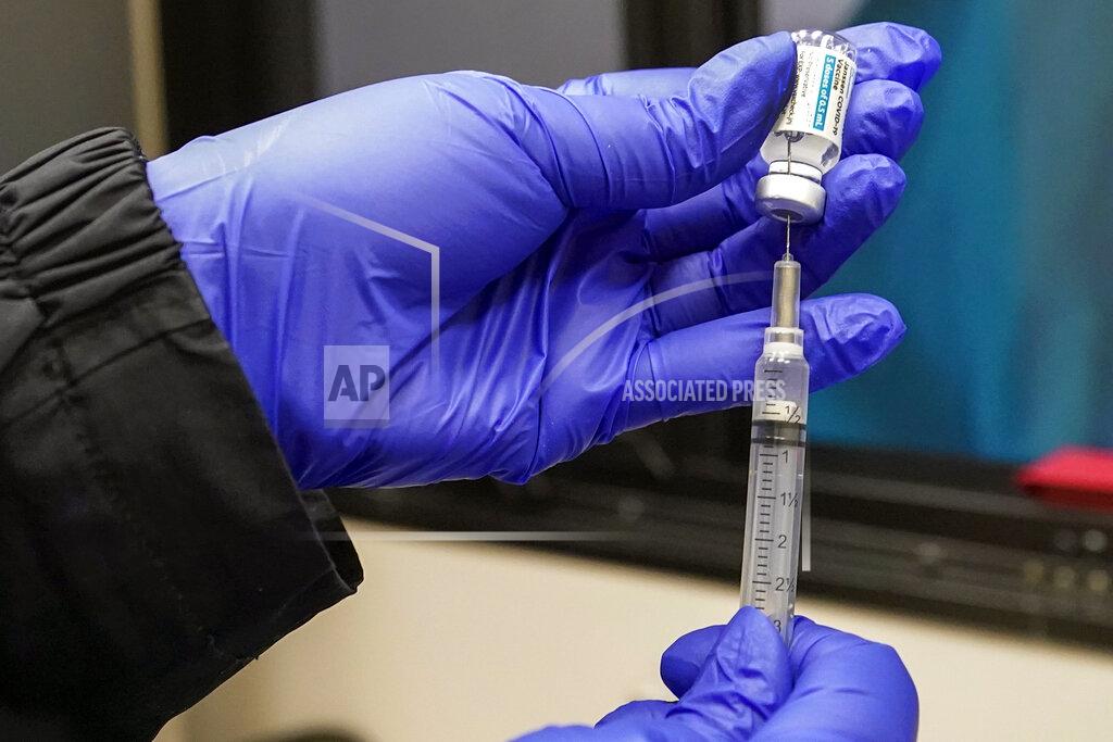 FILE — In this March 31, 2021, file photo, a nurse fills a syringe with Johnson & Johnson's one-dose COVID-19 vaccine at the Vaxmobile, at the Uniondale Hempstead Senior Center, in Uniondale, N.Y. U.S. health regulators on Tuesday, April 13, is recommending a “pause” in using the vaccine to investigate reports of potentially dangerous blood clots. (AP Photo/Mary Altaffer, File)