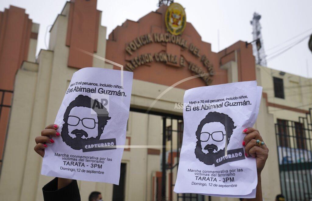 Martin Mejia People gather outside the anti-terrorism directorate to celebrate the death of Abimael Guzman, founder and leader of the Shining Path guerrilla movement, in Lima, Peru, Saturday, Sept. 11, 2021. Guzman, who was captured in 1992, died on Saturday in a military hospital after an illness, the Peruvian government said. He was 86. (AP Photo/Martin Mejia)