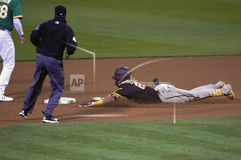 Tony Avelar San Diego Padres' Fernando Tatis Jr., right, slides into second base on a double that scored two runs against the Oakland Athletics during the fifth inning of a baseball game in Oakland, Calif., Friday, Sept. 4, 2020. (AP Photo/Tony Avelar)