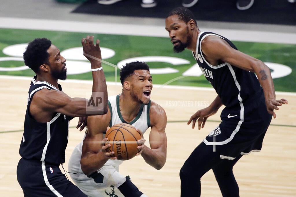 Aaron Gash Milwaukee Bucks' Giannis Antetokounmpo, middle, drives to the basket between Brooklyn Nets' Jeff Green, left, and Kevin Durant, right, during the first half of an NBA basketball game Tuesday, May 4, 2021, in Milwaukee. (AP Photo/Aaron Gash)