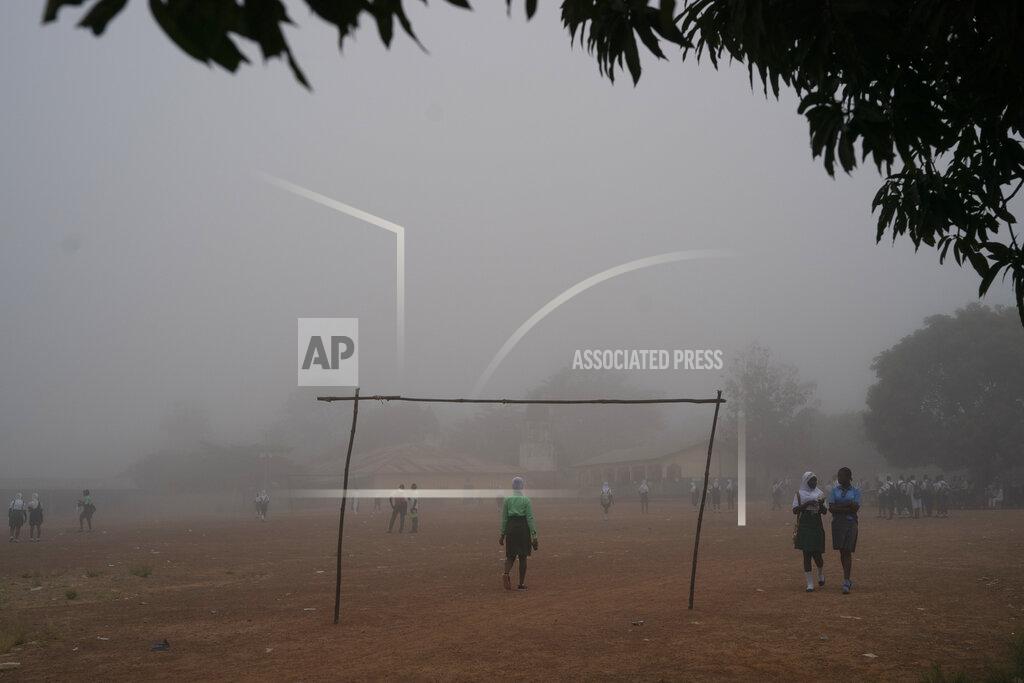 Leo Correa Students walks in the fog as they arrive at a secondary school in Koidu, district of Kono, Sierra Leone, Friday, Nov. 20, 2020. (AP Photo/Leo Correa)