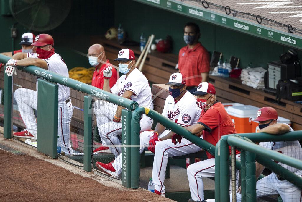 Alex Brandon Washington Nationals manager Dave Martinez, third from right, and all the others in the dugout, wear a masks during an exhibition baseball game against the Philadelphia Phillies at Nationals Park, Saturday, July 18, 2020, in Washington. (AP Photo/Alex Brandon)