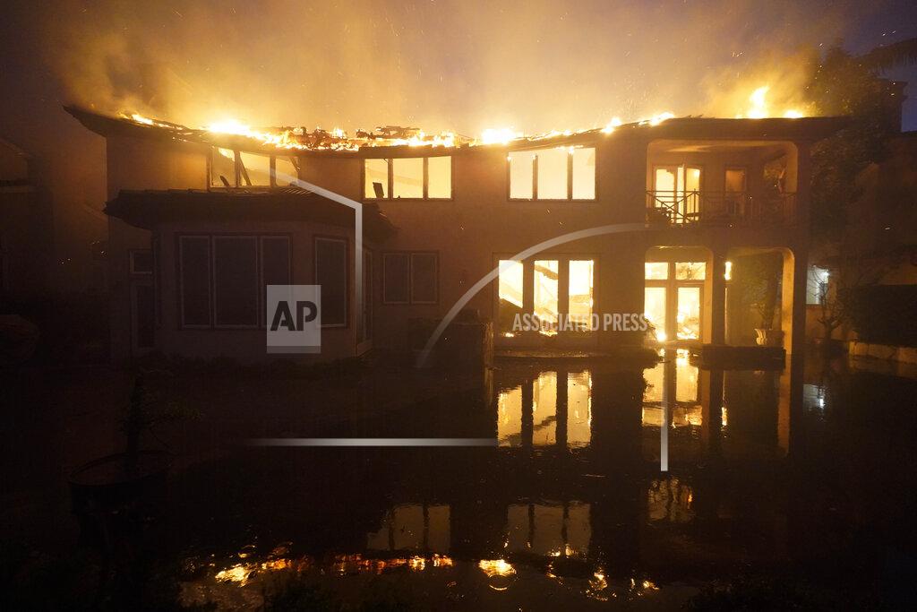 Marcio Jose Sanchez A structure burns during a wildfire Wednesday, May 11, 2022, in Laguna Niguel, Calif. (AP Photo/Marcio Jose Sanchez)