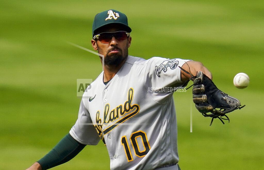 FILE - In this Wednesday, Sept. 16, 2020 file photo, Oakland Athletics shortstop Marcus Semien (10) catches a ball during the fourth inning of a baseball game against the Colorado Rockies in Denver. Shortstop Marcus Semien agreed to an $18 million, one-year contract with the Toronto Blue Jays, a person familiar with the negotiations told The Associated Press.(AP Photo/Jack Dempsey, File)