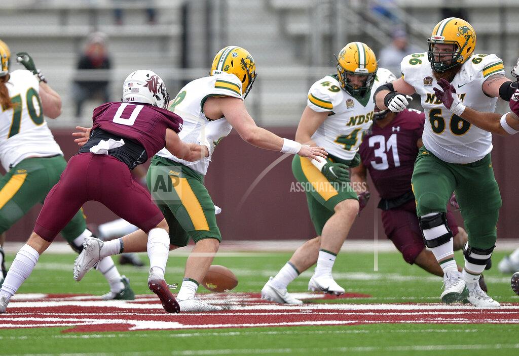 Byron Hetzler Southern Illinois safety Clayton Bush (0) forces a fumble by North Dakota State quarterback Zeb Noland (8) during the third quarter of an NCAA college football game Saturday, Feb. 29, 2021, in Carbondale, Ill. (Byron Hetzler/The Southern Illinoisan via AP)
