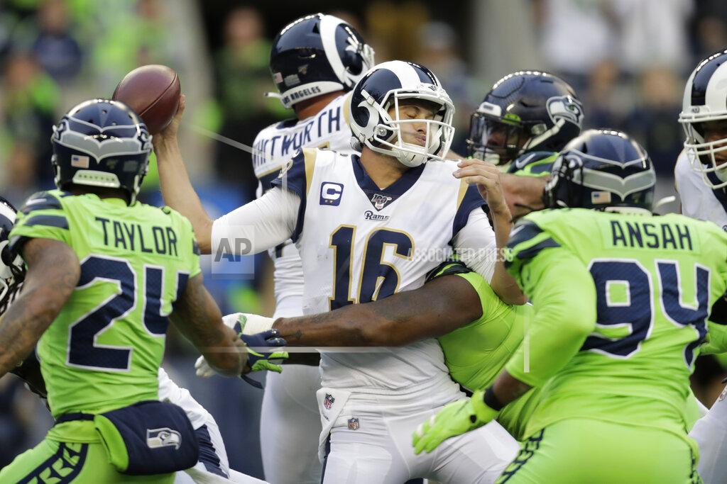 Stephen Brashear Los Angeles Rams quarterback Jared Goff, center, is tackled by Seattle Seahawks defensive tackle Quinton Jefferson, obscured, during the first half of an NFL football game Thursday, Oct. 3, 2019, in Seattle. (AP Photo/Stephen Brashear)