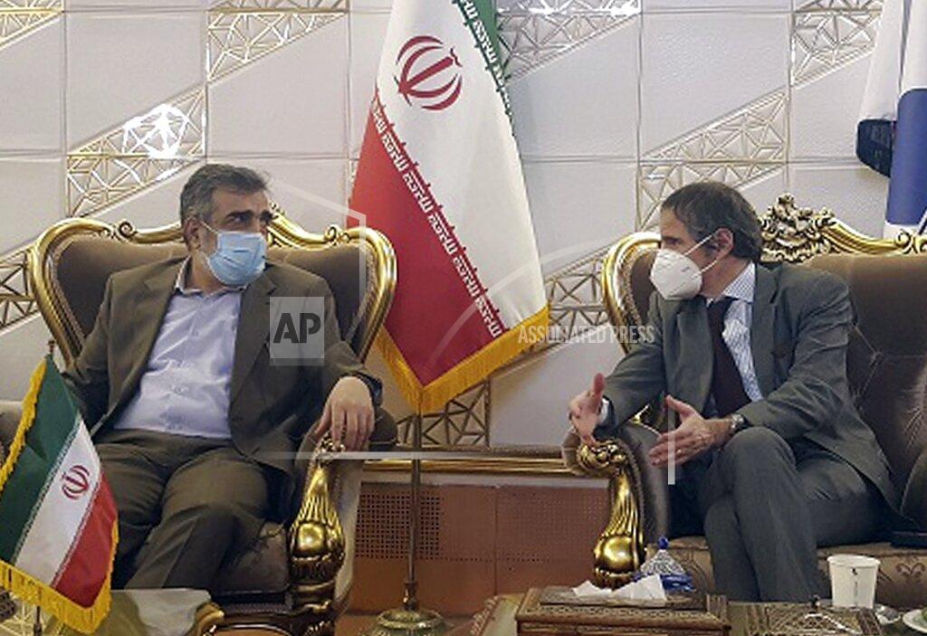 Uncredited FILE - In this Feb. 20, 2021, file photo, Director General of International Atomic Energy Agency, IAEA, Rafael Mariano Grossi, right, speaks with spokesman of Iran's atomic agency Behrouz Kamalvandi upon his arrival at Tehran's Imam Khomeini airport, Iran. Iran has said it plans to cease its implementation of the "Additional Protocol," a confidential agreement between Tehran and the IAEA reached as part of the landmark nuclear accord that grants the U.N. inspectors enhanced powers to visit nuclear facilities and watch Iran's program. (Atomic Energy Organization of Iran via AP, File)