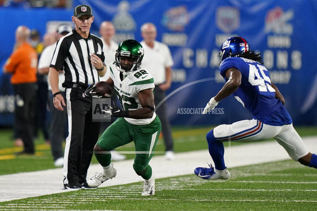 New York Jets wide receiver Jamison Crowder (82) runs the ball next to New York Giants cornerback Madre Harper (45) during the first half of an NFL preseason football game Saturday, Aug. 14, 2021, in East Rutherford, N.J. (AP Photo/Corey Sipkin)
