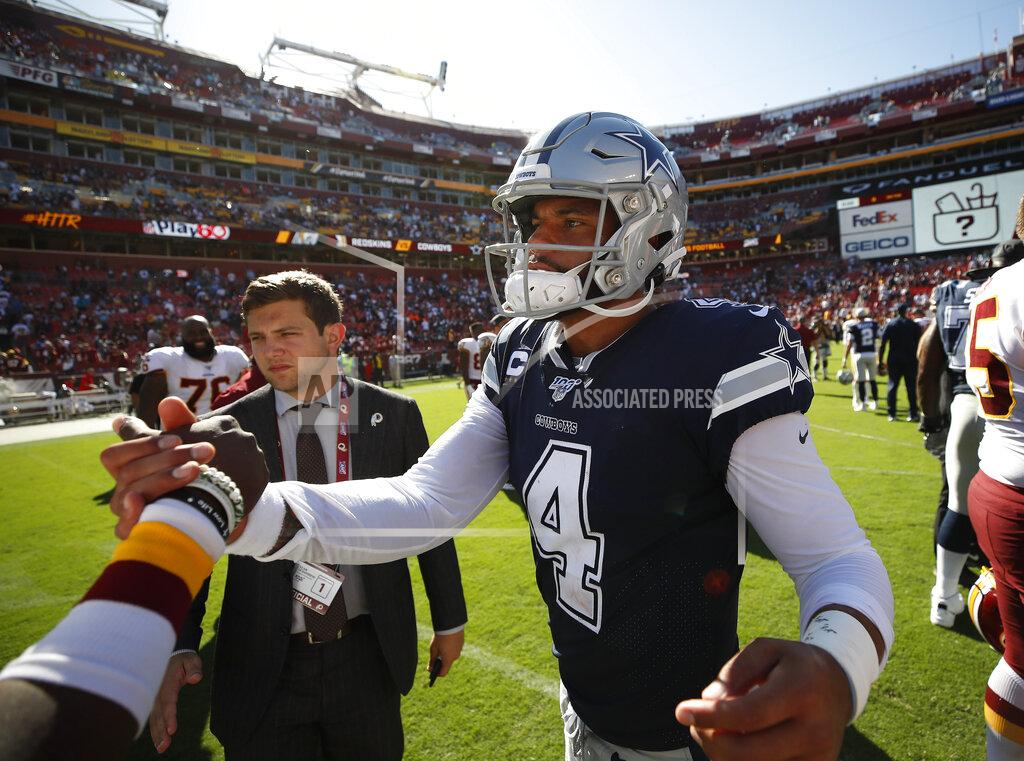Dallas Cowboys quarterback Dak Prescott (4) greets Washington Redskins players on the field at the end of the NFL football game, Sunday, Sept. 15, 2019, in Landover, Md. Dallas won 31-21. (AP Photo/Alex Brandon)