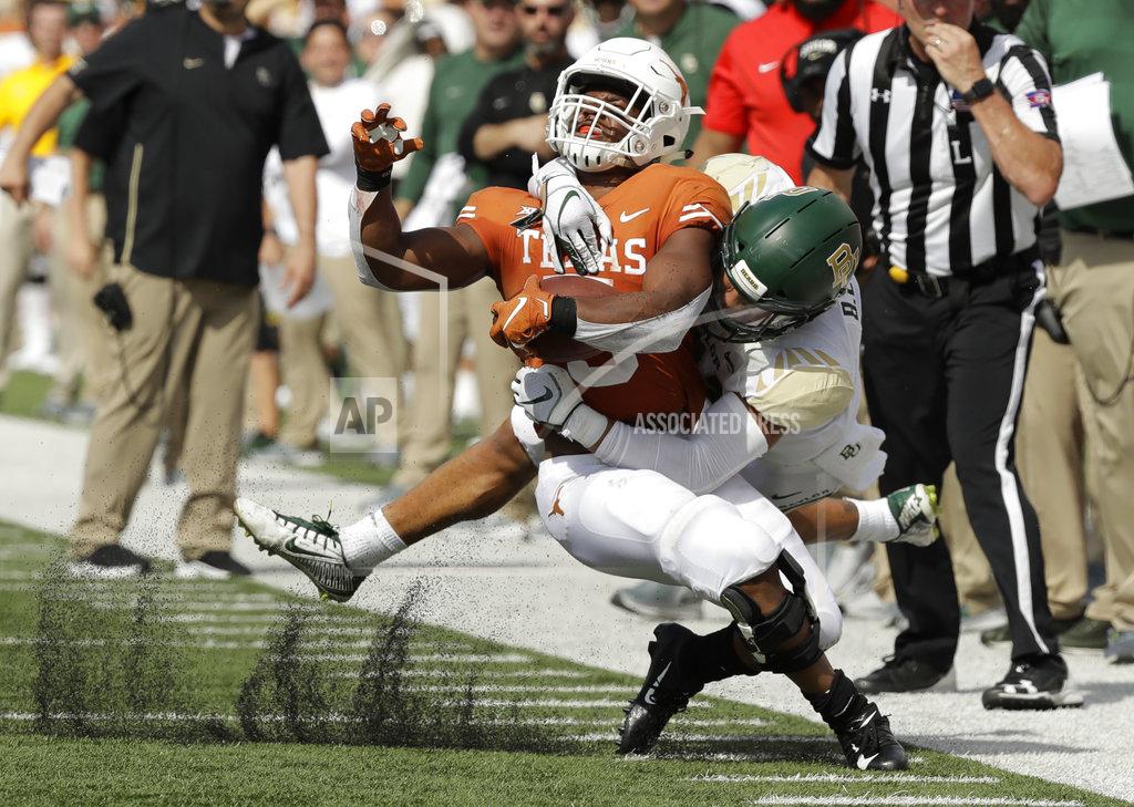 Eric Gay Texas running back Tre Watson (5) is hit by Baylor safety Blake Lynch, front right, after making a catch during the first half of an NCAA college football game, Saturday, Oct. 13, 2018, in Austin, Texas. (AP Photo/Eric Gay)
