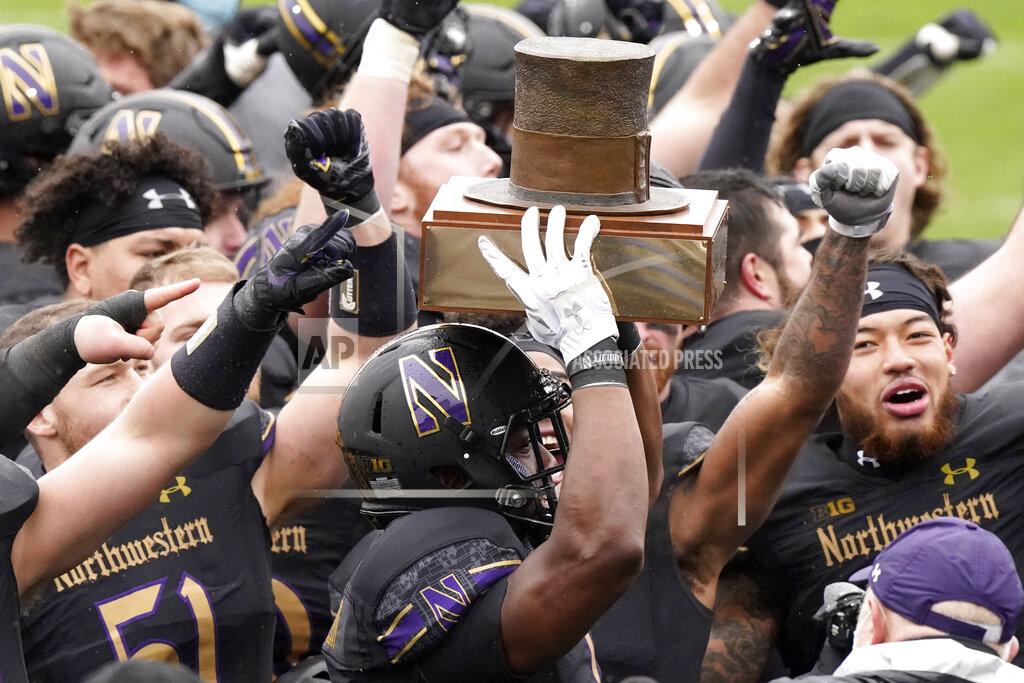Nam Y. Huh Northwestern running back Jesse Brown, center, celebrates with teammates as he holds the Land of Lincoln Trophy after Northwestern defeated Illinois 28-10 in an NCAA college football game in Evanston, Ill., Saturday, Dec. 12, 2020. (AP Photo/Nam Y. Huh)