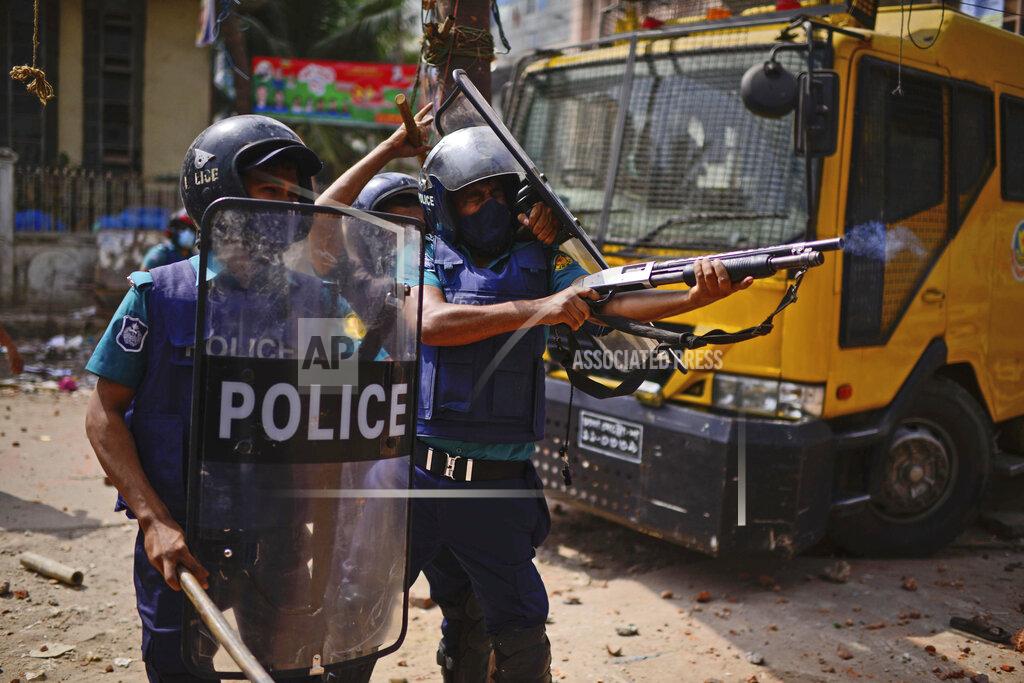 Mahmud Hossain Opu Security officers disperse demonstrators protesting against the visit of Indian Prime Minister Narendra Modi after Friday prayers at Baitul Mokarram mosque in Dhaka, Bangladesh, Friday, March 26, 2021. Witnesses said violent clashes broke out after one faction of protesters began waving their shoes as a sign of disrespect to Indian Prime Minister Narendra Modi, and another group tried to stop them. Local media said the protesters who tried to stop the shoe-waving are aligned with the ruling Awami League party. The party criticized the other protest faction for attempting to create chaos in the country during Modi’s visit. (AP Photo/Mahmud Hossain Opu)
