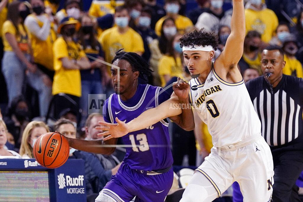Carlos Osorio Tarleton State guard Shakur Daniel (13) is fouled by Michigan guard Adrien Nunez (0) during the first half of an NCAA college basketball game, Wednesday, Nov. 24, 2021, in Ann Arbor, Mich. (AP Photo/Carlos Osorio)