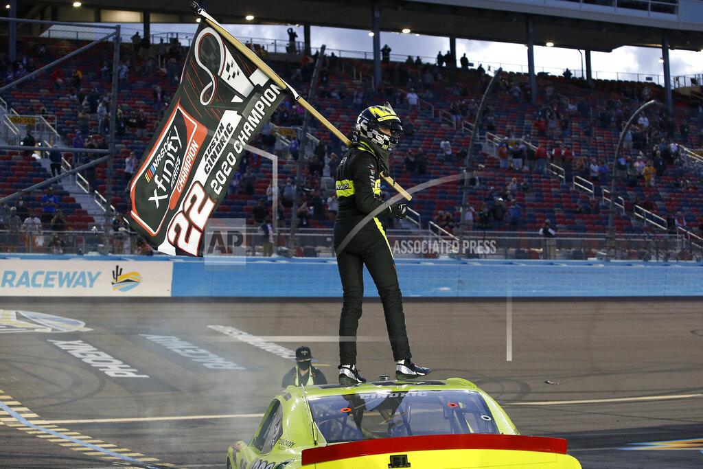 Ralph Freso Austin Cindric stands on the roof of his race car holding a season champion banner after winning the NASCAR Xfinity Series auto race at Phoenix Raceway, Saturday, Nov. 7, 2020, in Avondale, Ariz. (AP Photo/Ralph Freso)