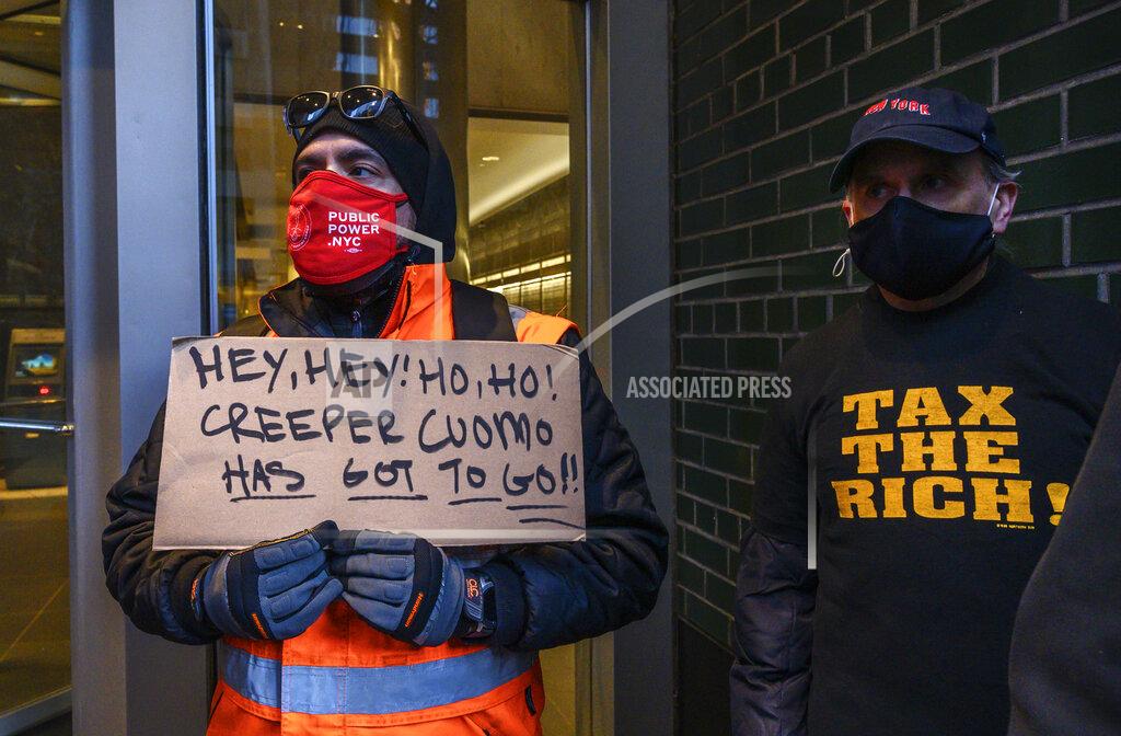 Brittainy Newman John Vosarogo, 38, left, and other demonstrators rally for New York Gov. Andrew Cuomo's resignation in front of his Manhattan office in New York, Tuesday, March 2, 2021. Cuomo has avoided public appearances for days as some members of his own party call for him to resign over sexual harassment allegations. (AP Photo/Brittainy Newman)