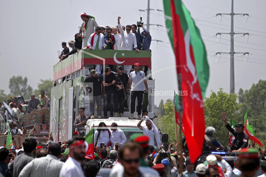 Mohammad Zubair Ousted Pakistani Prime Minister Imran Khan raises a fist to supporters as he leads a march toward Islamabad, in Swabi, Pakistan, Wednesday, May 25, 2022. Pakistani police have fired tear gas and scuffled with stone-throwing supporters of Khan as they gathered for planned marches Wednesday toward central Islamabad. The defiant former premier had called followers to a rally outside Parliament to bring down the government and force early elections. (AP Photo/Mohammad Zubair)
