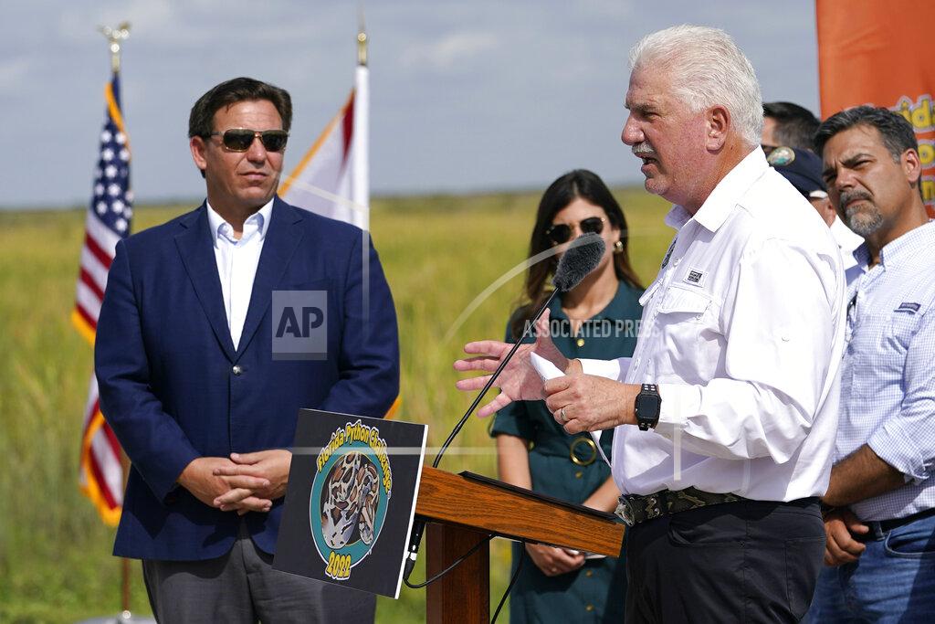 Lynne Sladky Florida Fish and Wildlife Conservation Commission (FWC) Chairman Rodney Barreto, right, speaks at a media event where Florida Gov. Ron DeSantis, left, announced that registration for the 2022 Florida Python Challenge has opened for the annual 10-day event to be held Aug 5-14, Thursday, June 16, 2022, in Miami. The Python Challenge is intended to engage the public in participating in Everglades conservation through invasive species removal of the Burmese python. (AP Photo/Lynne Sladky)