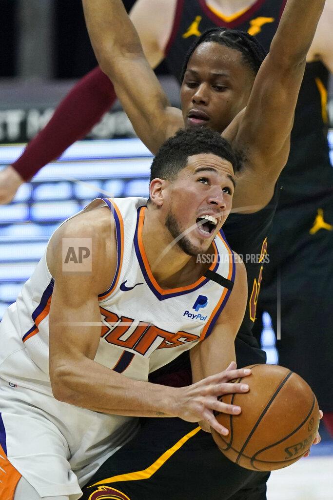 Tony Dejak Phoenix Suns' Devin Booker (1) drives against Cleveland Cavaliers' Isaac Okoro (35) in the first half of an NBA basketball game, Tuesday, May 4, 2021, in Cleveland. (AP Photo/Tony Dejak)