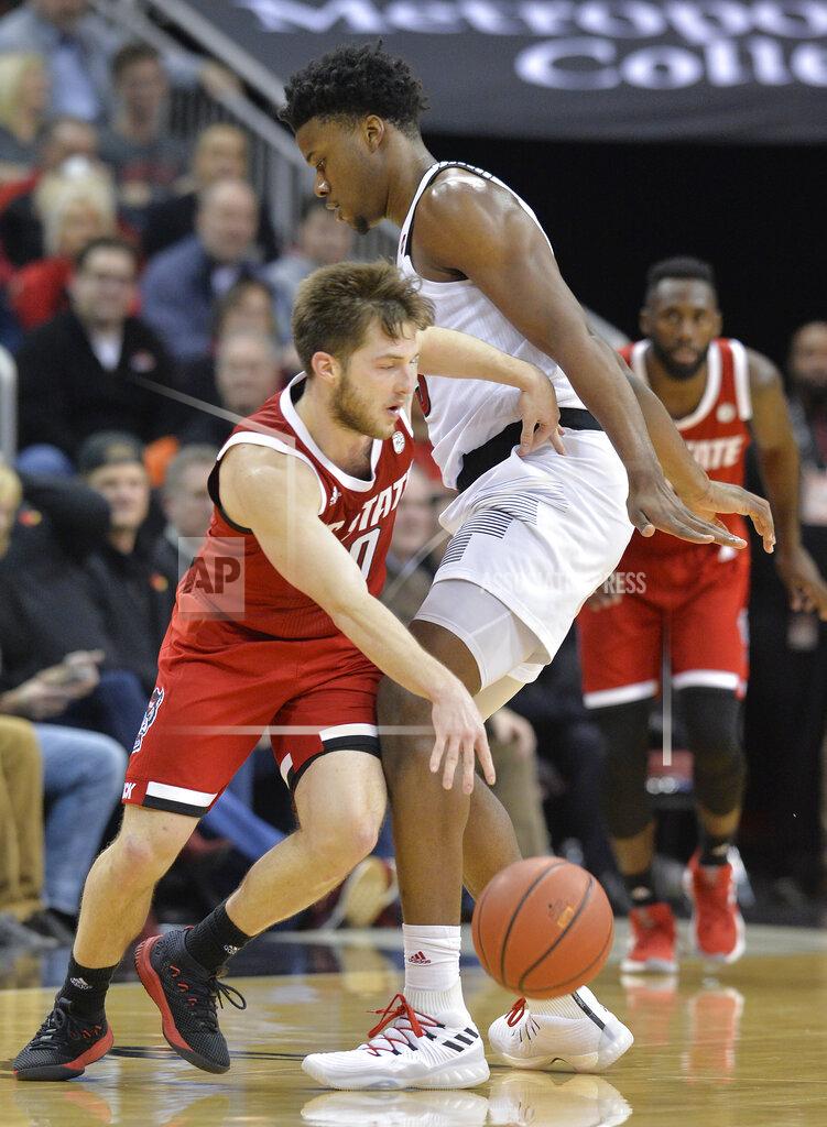 Timothy D. Easley North Carolina State guard Braxton Beverly (10) nights his way around Louisville center Steven Enoch (23) during the second half of an NCAA college basketball game in Louisville, Ky., Thursday, Jan. 24, 2019. Louisville won 84-77. (AP Photo/Timothy D. Easley)