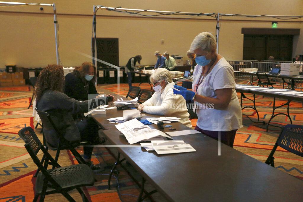 Cedar Attanasio Election workers sort electronically submitted ballots at the Santa Fe Convention Center on Election Day, Tuesday, Nov. 3, 2020, in Santa Fe, N.M. (AP Photo/Cedar Attanasio)