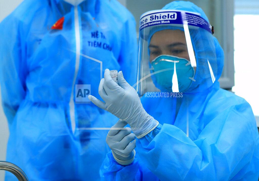 Hau Dinh A health worker prepares a dose of AstraZeneca COVID-19 vaccine at Hospital for Tropical Diseases in Hanoi, Vietnam Monday, March 8, 2021. Vietnam has started the vaccination campaign with a hope to inoculate half of the population of 96 millions against COVID-19 by the end of the year. (AP Photo/Hau Dinh)