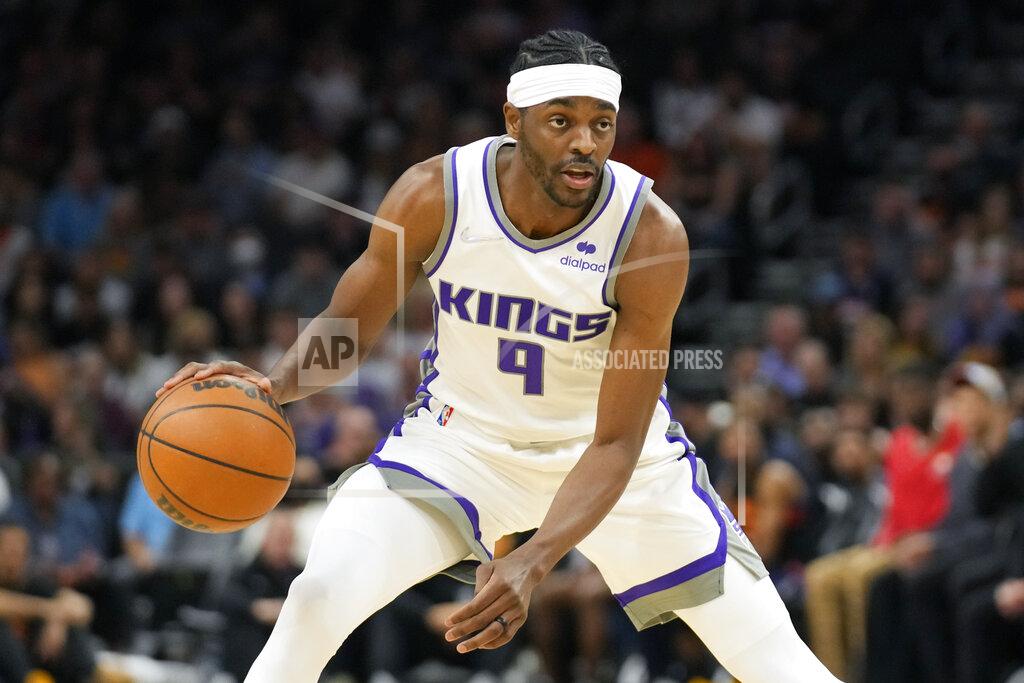 Rick Scuteri FILE - Sacramento Kings forward Justin Holiday (9) plays during the first half of an NBA basketball game against the Phoenix Suns, Sunday, April 10, 2022, in Phoenix. The Atlanta Hawks are trading Kevin Huerter to the Sacramento Kings for Justin Holiday, Mo Harkless and a future conditional draft pick, according to a person with direct knowledge of the agreement. The person spoke to The Associated Press on condition of anonymity Friday, July 1, 2022, because the trade had not been formally approved by the NBA and announced by either club. (AP Photo/Rick Scuteri, File)