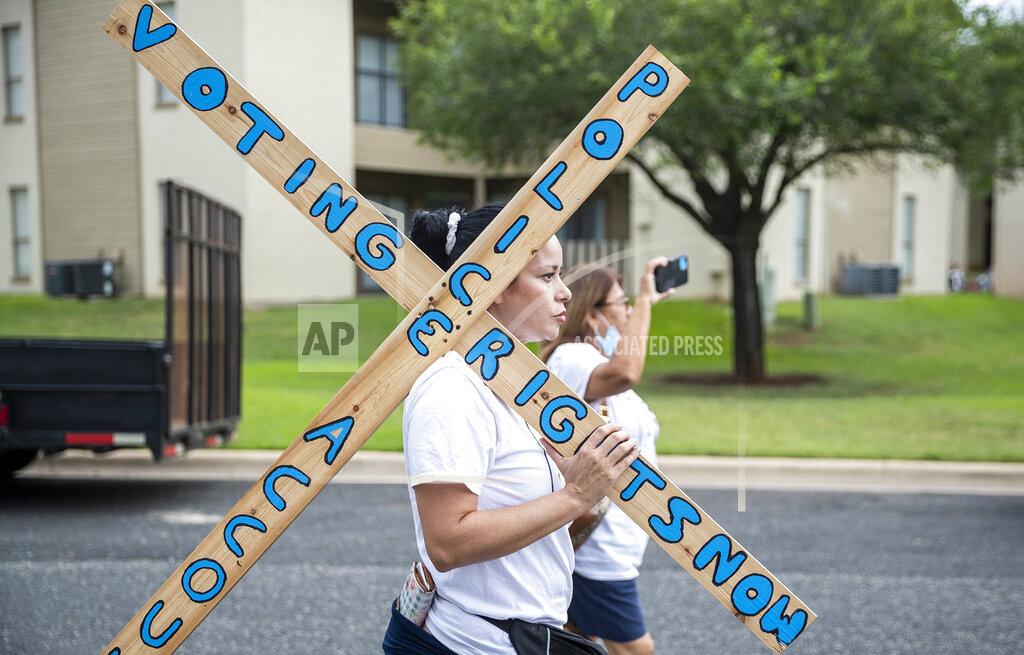 Ricardo B. Brazziell Linda Nuno walks in a march for democracy from Georgetown, Texas to the Texas State Capitol in downtown Austin. Church leaders and former Democratic congressman Beto O'Rourke are leading a nearly 30-mile voting rights march in Texas. The walk began Wednesday with nearly 100 participants in suburban Austin and will is scheduled to end this weekend at the state Capitol. The march is the latest effort by Democrats to keep up the pressure over voting rights at a time when the prospects of action from Congress is fading. (Ricardo B. Brazziell/Austin American-Statesman via AP)