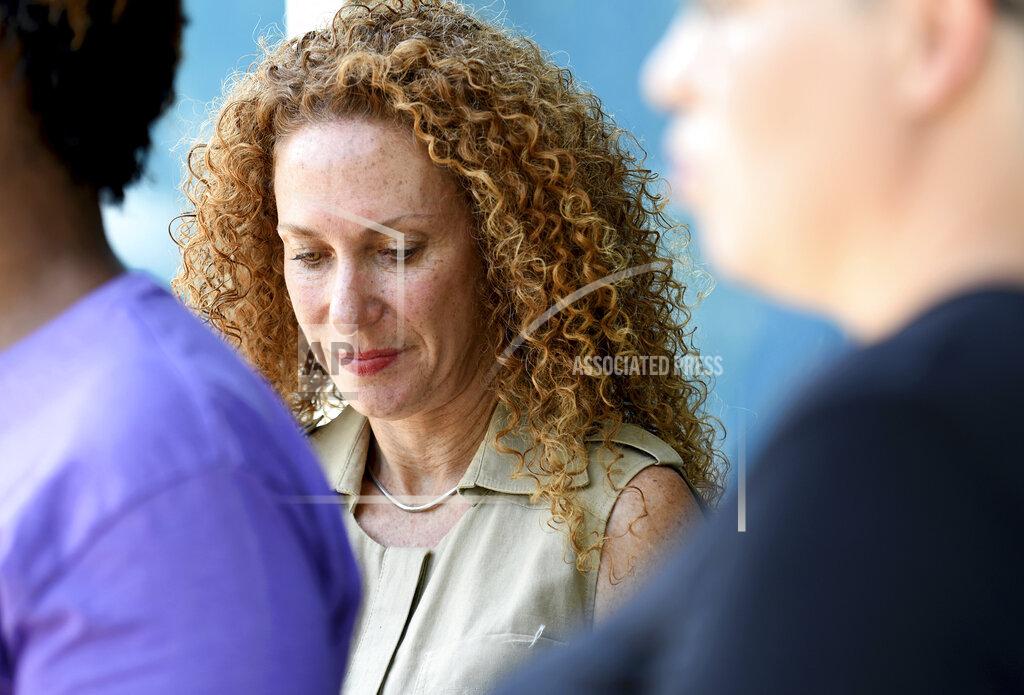 Thomas Peipert Civil rights attorney Mari Newman listens to a news conference in Aurora, Colorado, on Wednesday, July 28, 2021. Local activists and former members of Aurora's community police task force gathered to call attention to police brutality. Aurora police announced Monday that an officer was arrested after video showed him using his pistol to beat a man he was trying to take into custody, choking him and threatening to kill him, while another officer was accused of failing to stop her colleague. (AP Photo/Thomas Peipert)