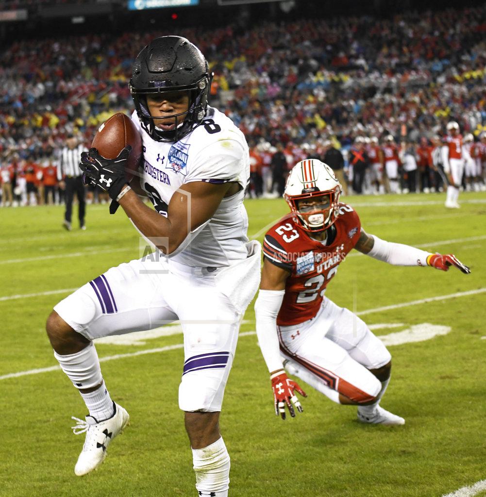 Denis Poroy Northwestern wide receiver Kyric McGowan (8) makes a catch in front of the defense of Utah defensive back Julian Blackmon (23) during the first half of the Holiday Bowl NCAA college football game Monday, Dec. 31, 2018, in San Diego. (AP Photo/Denis Poroy)
