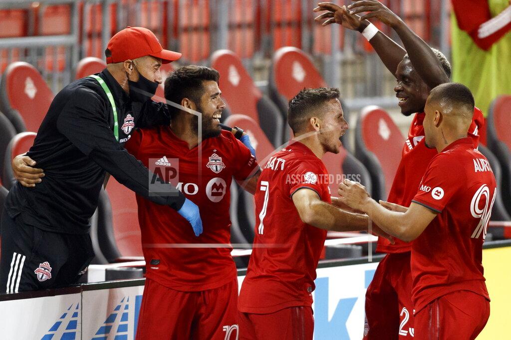 Cole Burston Toronto FC forward Pablo Piatti (7) celebrates his goal alongside team-mates midfielder Alejandro Pozuelo (10), Toronto FC midfielder Richie Laryea (22), and Toronto FC defender Auro (96) during first half MLS soccer action against the Vancouver Whitecaps at BMO field in Toronto, Tuesday, Aug. 18, 2020. (Cole Burston/The Canadian Press via AP)