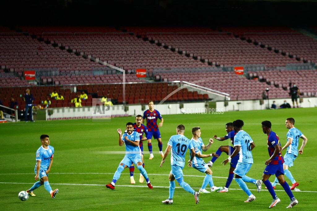 Joan Monfort Barcelona's Ansu Fati, center right, kicks the ball to score the opening goal during the Spanish La Liga soccer match between FC Barcelona and Leganes at the Camp Nou stadium in Barcelona, Spain, Tuesday, June 16, 2020. (AP Photo/Joan Montfort)