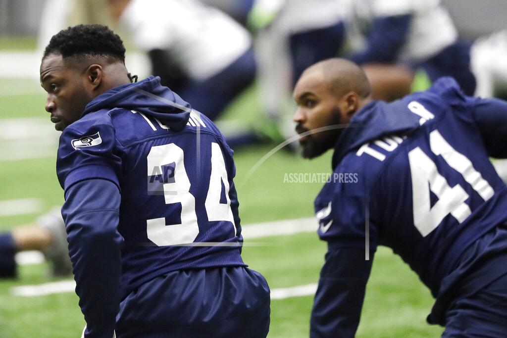 Ted S. Warren Seattle Seahawks running back Robert Turbin, left, stretches next to practice squad running back Xavier Turner, right, before NFL football practice, Friday, Dec. 27, 2019, in Renton, Wash. (AP Photo/Ted S. Warren)