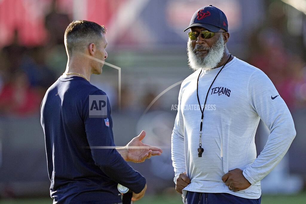 David J. Phillip Houston Texans general manager Nick Caserio, left, talks with coach Lovie Smith during an NFL football training camp practice Friday, July 29, 2022, in Houston. (AP Photo/David J. Phillip)
