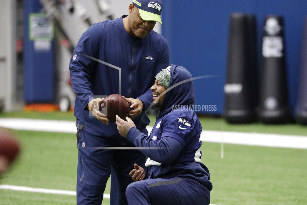 Elaine Thompson Seattle Seahawks running back Marshawn Lynch, right, talks with defensive coordinator Ken Norton Jr. during warmups at the NFL football team's practice facility Tuesday, Dec. 24, 2019, in Renton, Wash. When Lynch played his last game for the Seahawks in 2016, the idea of him ever wearing a Seahawks uniform again seemed preposterous. Yet, here are the Seahawks getting ready to have Lynch potentially play a major role Sunday against San Francisco with the NFC West title on the line. (AP Photo/Elaine Thompson)