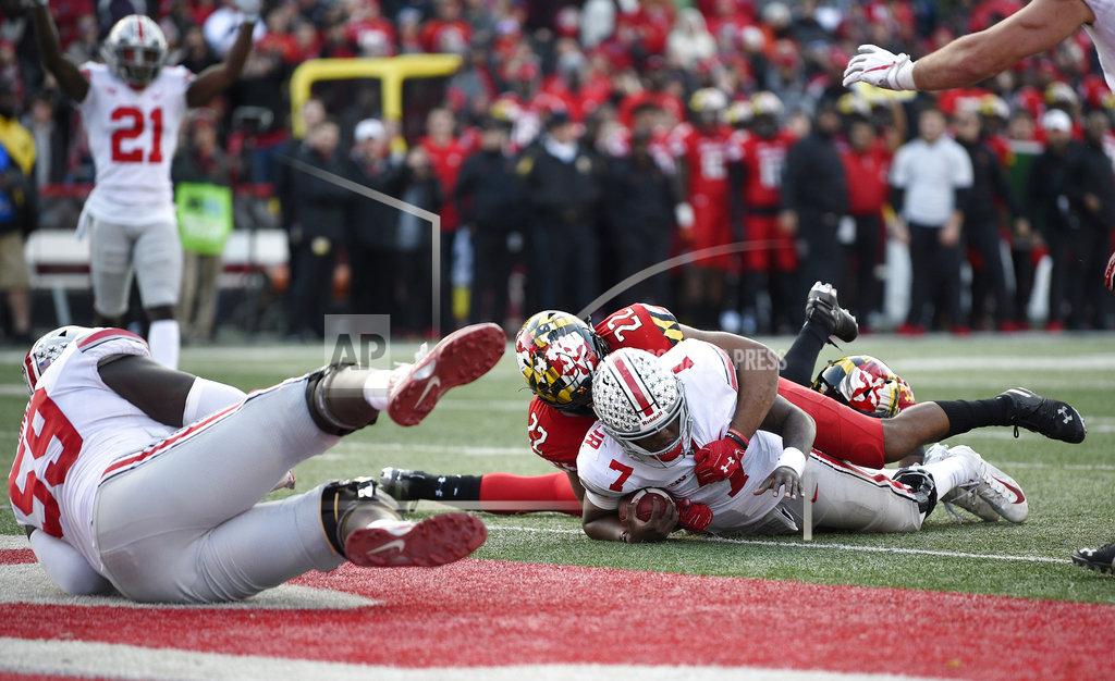 Nick Wass Ohio State quarterback Dwayne Haskins Jr. (7) lies on the end zone after he scored a touchdown during overtime of an NCAA football game against Maryland linebacker Isaiah Davis (22), Saturday, Nov. 17, 2018, in College Park, Md. Ohio State won 52-51 in overtime. (AP Photo/Nick Wass)