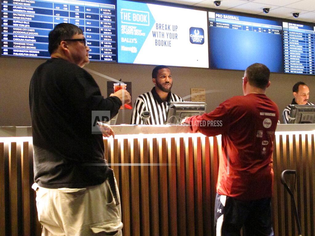 Wayne Parry FILE - A gambler makes a sports bet at Bally's casino in Atlantic City N.J., Sept. 5, 2019. A record 31.5 million Americans plan to bet on this year's Super Bowl, according to the gambling industry's national trade group. The American Gaming Association on Tuesday, Feb. 8, 2022, released its annual predictions for wagering on pro football's championship game, forecasting that over $7.6 billion will be bet legally and otherwise. (AP Photo/Wayne Parry, File)
